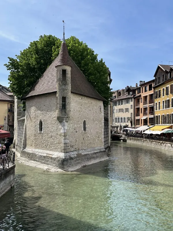 The Palais de l’Isle, a medieval stone building on a small island in the Thiou canal