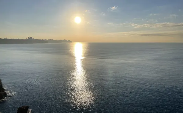 The early sun laying a glittering path across the calm sea off Antalya’s cliffs