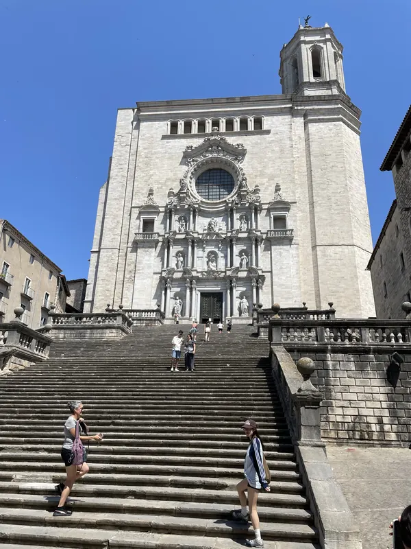 The broad stone stairway climbing to the Baroque front of Girona Cathedral
