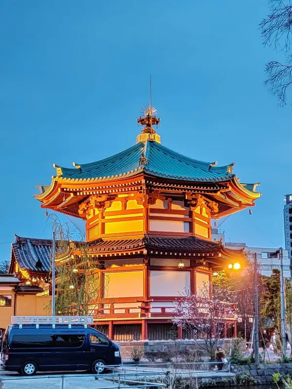 The octagonal Bentendo Hall in Ueno glowing orange at dusk under a deep blue sky