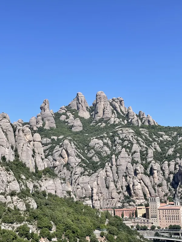 Jagged rock pinnacles of Montserrat above the monastery buildings