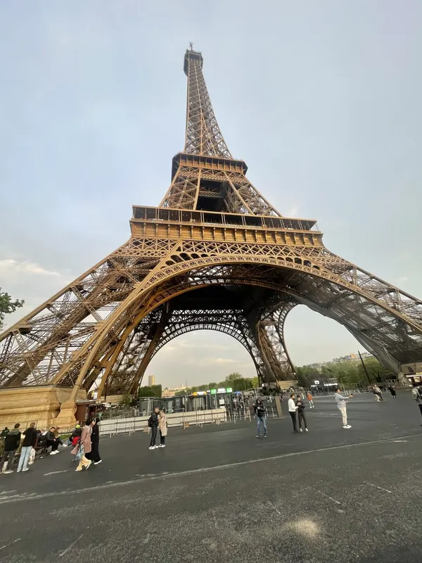 Looking up at the Eiffel Tower from below in soft evening light