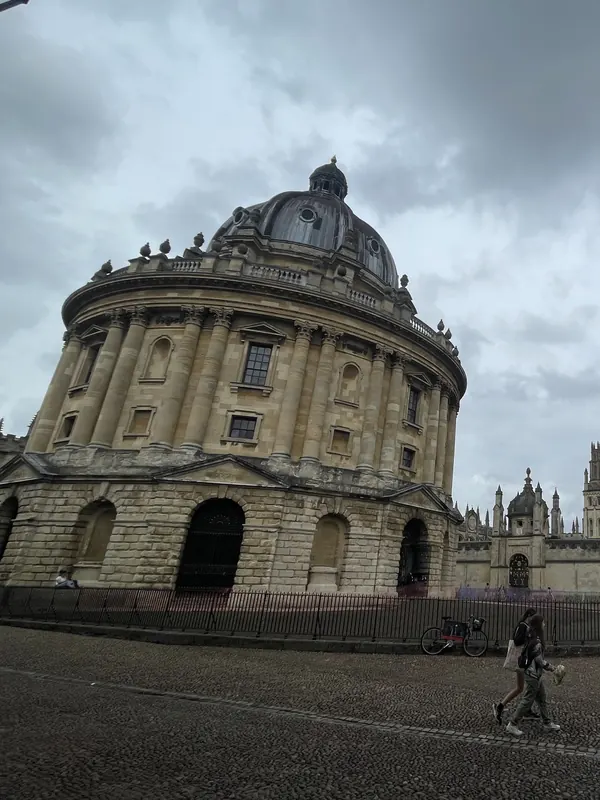 The domed, round Radcliffe Camera library in Oxford under a stormy sky