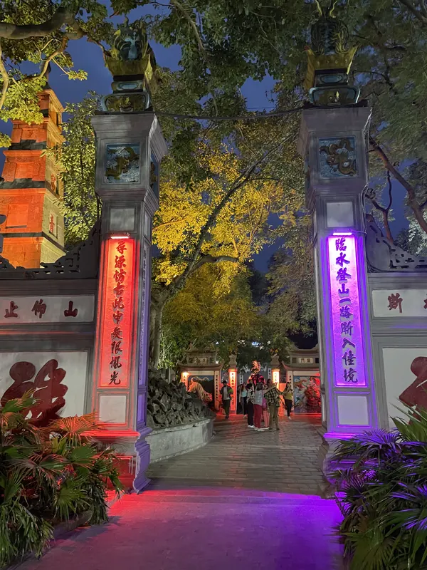 The lantern-lit gate to Ngoc Son Temple on Hoan Kiem Lake in Hanoi at dusk